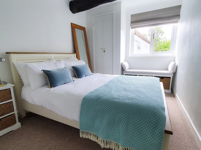 The double bedroom is bright and comprises a double bed, a wardrobe and drawers.