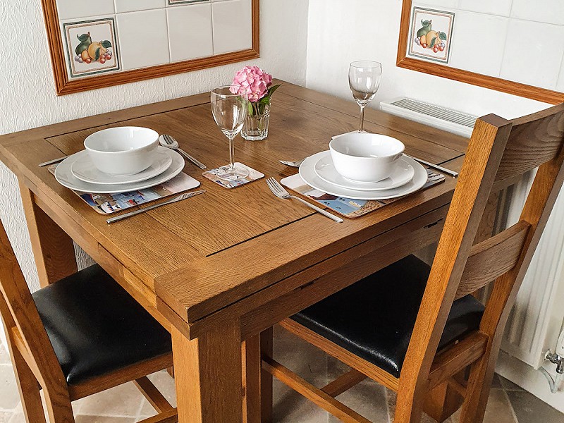 The kitchen features an intimate and inviting space for sharing meal times.