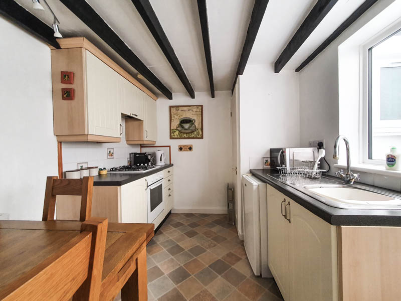 A quaint kitchen/diner provides all the essentials for mealtimes, with a cooker, hob, microwave and refrigerator.